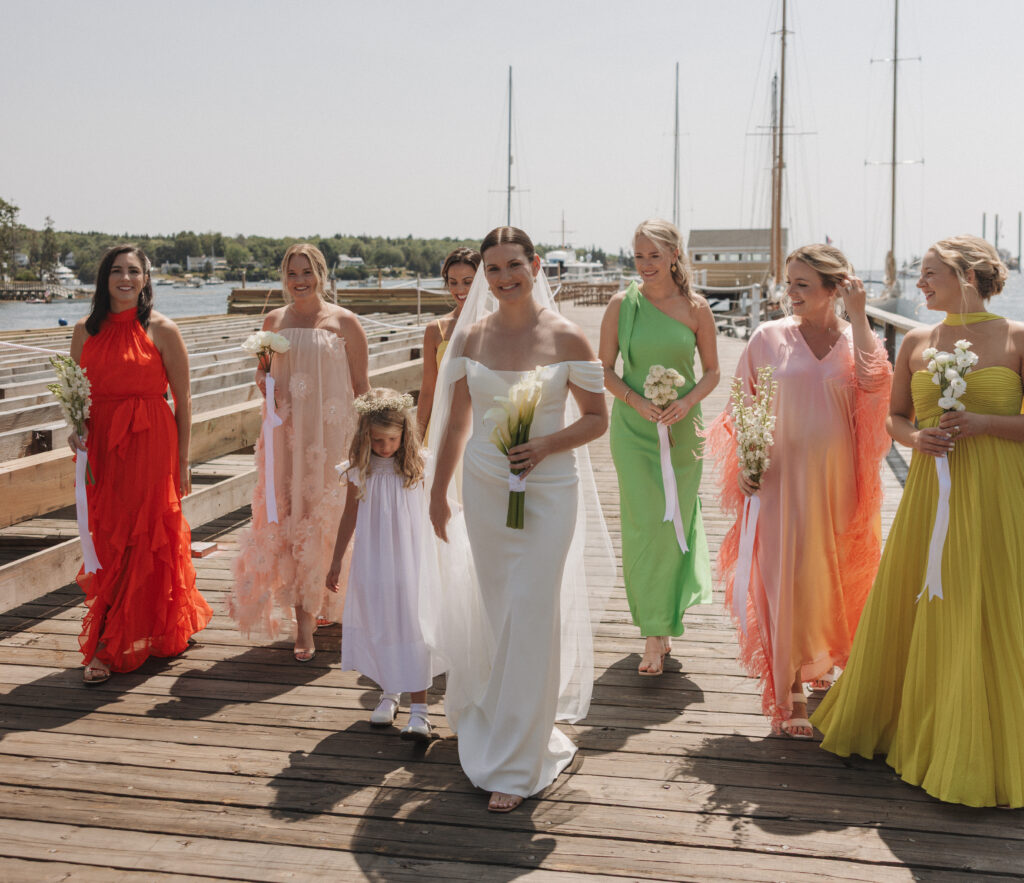 Coastal Maine wedding with bride and bridesmaids in bright colors.