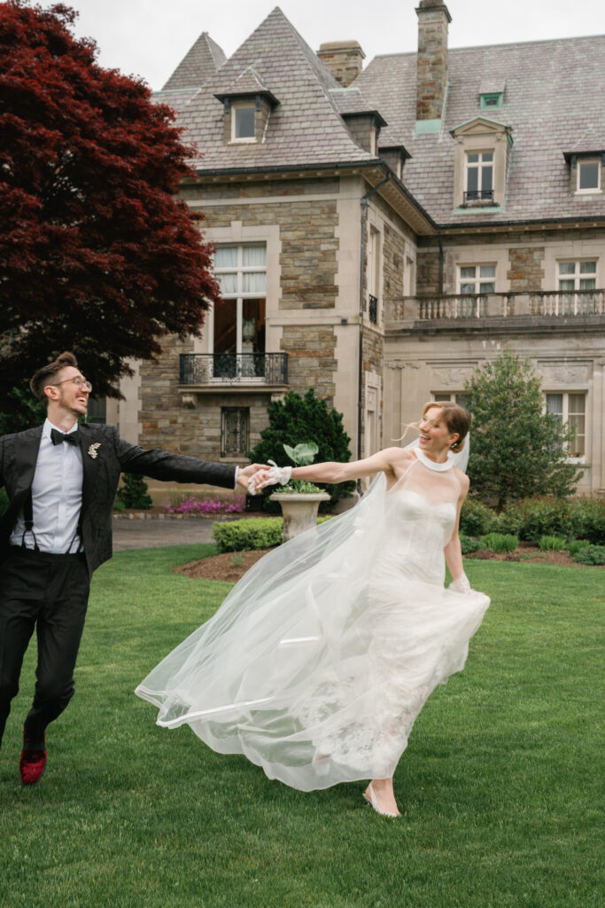Bride and Groom Running on the front lawn at Aldrich Mansion in Rhode Island. 
