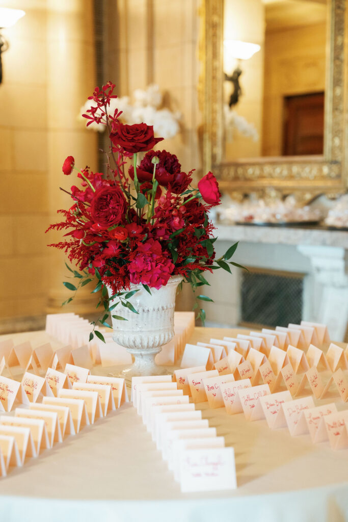 Escort Card Table with luxurious red flower arrangement. 