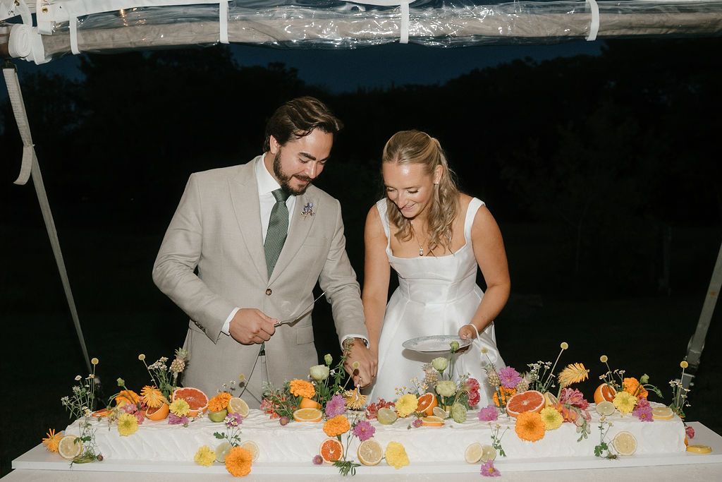 Cake cutting at tented wedding in Kennebunk, Maine. 